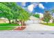 Charming single Gathering home with a well-manicured lawn and mature landscaping at 1610 Stetson Dr, Wesley Chapel, FL 33543
