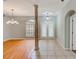 Bright foyer with tile flooring, a decorative column, and natural light from front windows at 1610 Stetson Dr, Wesley Chapel, FL 33543