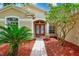 Inviting front entrance with red double doors, tile pathway, and lush landscaping at 1610 Stetson Dr, Wesley Chapel, FL 33543