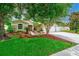 Well-manicured lawn and landscaped front yard leading to a charming home with a three-car garage at 1610 Stetson Dr, Wesley Chapel, FL 33543