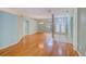 Open-concept living room featuring hardwood floors and abundant natural light at 1610 Stetson Dr, Wesley Chapel, FL 33543