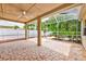 Covered patio with unique flooring and a screened-in area at 1610 Stetson Dr, Wesley Chapel, FL 33543