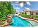 Gorgeous backyard pool with a spa and well-manicured landscaping at 1610 Stetson Dr, Wesley Chapel, FL 33543