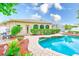 Backyard with a pool that has a unique shape, lovely landscaping, and beautiful pavers at 1610 Stetson Dr, Wesley Chapel, FL 33543