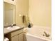 Relaxing bathroom featuring a soaking tub, vanity with sink, and neutral color palette at 16511 Enclave Village Dr # 107, Tampa, FL 33647