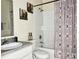 Bathroom featuring a tiled shower/tub combination, a vanity with a sink, and neutral decor at 16511 Enclave Village Dr # 107, Tampa, FL 33647