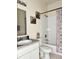 Bathroom featuring a tiled shower/tub combination, a vanity with a sink, and neutral decor at 16511 Enclave Village Dr # 107, Tampa, FL 33647
