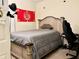 Cozy bedroom with a stylish bed frame and neutral-toned bedding, illuminated by a modern lamp at 16511 Enclave Village Dr # 107, Tampa, FL 33647