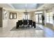 Elegant dining room with a large table, chandelier, and views of the outdoor pool area at 16511 Enclave Village Dr # 107, Tampa, FL 33647