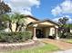 Community clubhouse featuring a covered entrance with columns, neat landscaping, and a welcoming facade at 16511 Enclave Village Dr # 107, Tampa, FL 33647