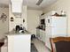 Efficient kitchen with white cabinets, practical appliances, and a cozy breakfast bar setup at 16511 Enclave Village Dr # 107, Tampa, FL 33647