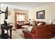 Comfortable living room with leather furniture, neutral walls, and a decorative window treatment at 16511 Enclave Village Dr # 107, Tampa, FL 33647