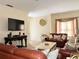Inviting living room with comfortable leather furniture, decorative window treatment, and mounted TV at 16511 Enclave Village Dr # 107, Tampa, FL 33647