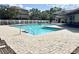 Community pool area featuring lounge chairs, landscaping, and views of the surrounding buildings at 16511 Enclave Village Dr # 107, Tampa, FL 33647