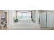 Bright bathroom with tub, glass enclosed shower and natural lighting at 1710 Lago Vista Blvd, Palm Harbor, FL 34685