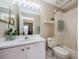 Cozy bathroom with a combined tub and shower, complemented by a classic vanity and toilet at 1710 Lago Vista Blvd, Palm Harbor, FL 34685