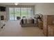 Spacious bedroom features neutral decor, fireplace, access to balcony with seating and a beautiful water view at 1710 Lago Vista Blvd, Palm Harbor, FL 34685