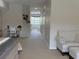 Bedroom view including a desk and chair, seating area, and hallway to the bathroom at 1710 Lago Vista Blvd, Palm Harbor, FL 34685