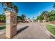 View of the Eagles Reserve community entrance, showcasing manicured landscaping and community flags at 1710 Lago Vista Blvd, Palm Harbor, FL 34685