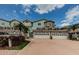 Charming townhomes featuring attached garages and a well-maintained brick driveway with palm trees at 1710 Lago Vista Blvd, Palm Harbor, FL 34685