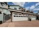Exterior shot of attached garage with brick pavers in the driveway with a well manicured landscape at 1710 Lago Vista Blvd, Palm Harbor, FL 34685