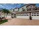 Inviting townhome with terra cotta driveway, arched windows and attached garage offer charm and convenience at 1710 Lago Vista Blvd, Palm Harbor, FL 34685