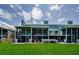 Spacious backyard featuring well-maintained green space and screened in patios at 1710 Lago Vista Blvd, Palm Harbor, FL 34685