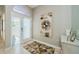 Bright foyer features tiled floors, a decorative rug and modern artwork at 1710 Lago Vista Blvd, Palm Harbor, FL 34685