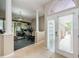 Bright home gym with mirrored wall, exercise equipment, pillars, neutral colors, and tiled floor at 1710 Lago Vista Blvd, Palm Harbor, FL 34685
