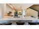 Elegant kitchen with white cabinets, quartz countertops, stainless steel appliances, and barstool seating at 1710 Lago Vista Blvd, Palm Harbor, FL 34685