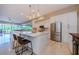 Open kitchen with stainless steel appliances, center island, ample counter space, and views of the living area at 1710 Lago Vista Blvd, Palm Harbor, FL 34685
