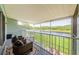 The lanai has a view of the lake and access to patio furniture at 1710 Lago Vista Blvd, Palm Harbor, FL 34685
