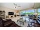 Spacious living room with tile flooring, a fireplace, and a sliding glass door to the patio at 1710 Lago Vista Blvd, Palm Harbor, FL 34685