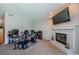 Bright living room with fireplace and mounted TV at 1710 Lago Vista Blvd, Palm Harbor, FL 34685