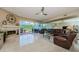 Spacious living room with fireplace, glass doors to outside patio and sleek tile flooring at 1710 Lago Vista Blvd, Palm Harbor, FL 34685