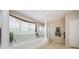 The main bathroom has a soaking tub, walk-in shower, and a view from large windows at 1710 Lago Vista Blvd, Palm Harbor, FL 34685