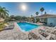 Inviting community pool with ample seating, shade, and lush landscaping at 1710 Lago Vista Blvd, Palm Harbor, FL 34685