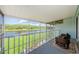 A covered porch with wicker chairs and a view of the river and forest at 1710 Lago Vista Blvd, Palm Harbor, FL 34685