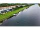 Scenic waterfront view of townhomes with private docks and lush green lawns at 1710 Lago Vista Blvd, Palm Harbor, FL 34685