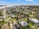 An aerial view showcases the home's location within a lush, green neighborhood near the water at 1720 Bayou Grande Ne Blvd, St Petersburg, FL 33703