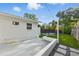 Back patio area leads to landscaped backyard with in-ground pool, artificial turf, and privacy fencing at 1720 Bayou Grande Ne Blvd, St Petersburg, FL 33703