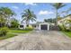 Charming one-story home with mature palm trees, a well-manicured lawn and attached garage at 1720 Bayou Grande Ne Blvd, St Petersburg, FL 33703