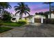 Charming single-story home with tropical landscaping, a driveway, and a one-car garage at 1720 Bayou Grande Ne Blvd, St Petersburg, FL 33703
