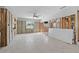Open-concept living room with bright lighting, block walls, and a ceiling fan at 1720 Bayou Grande Ne Blvd, St Petersburg, FL 33703
