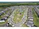 Aerial view of a residential community with a pool, playground, and well-maintained landscaping at 17714 Everlong Dr, Land O Lakes, FL 34638