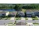An aerial view shows the home's lakeside location and neighborhood at 17714 Everlong Dr, Land O Lakes, FL 34638