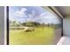 Scenic view of the backyard pond and lush greenery from the screened-in patio at 17714 Everlong Dr, Land O Lakes, FL 34638