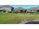 This home's backyard features a pond view, grass, and lush, green landscaping at 17714 Everlong Dr, Land O Lakes, FL 34638