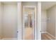 Hallway leading to the bathroom and walk-in closet with tile flooring at 17714 Everlong Dr, Land O Lakes, FL 34638