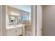 Modern bathroom featuring a glass-enclosed shower, white vanity, and tiled walls, offering a clean and stylish design at 17714 Everlong Dr, Land O Lakes, FL 34638